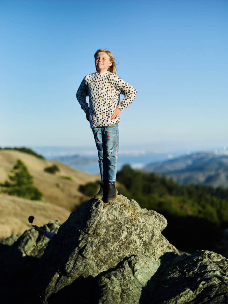 confidant girl standing on a rock