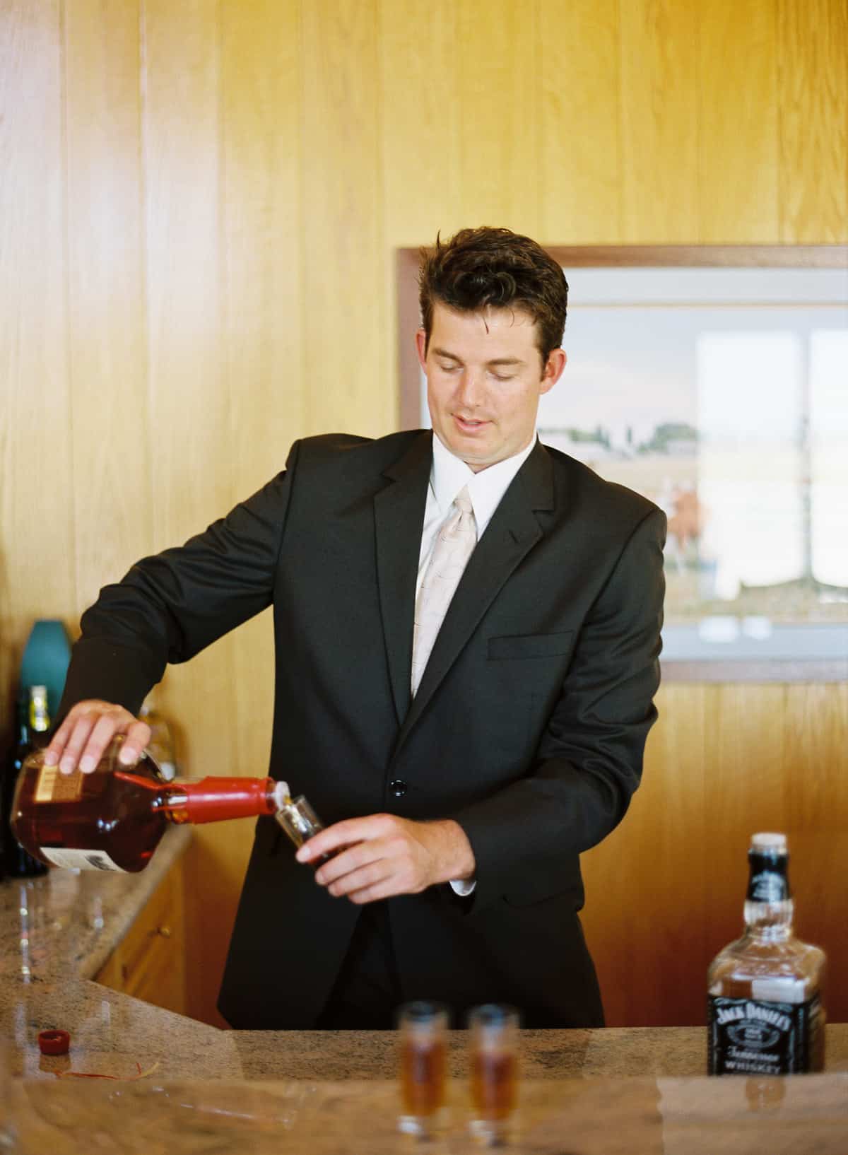 Groomsman pouring a drink