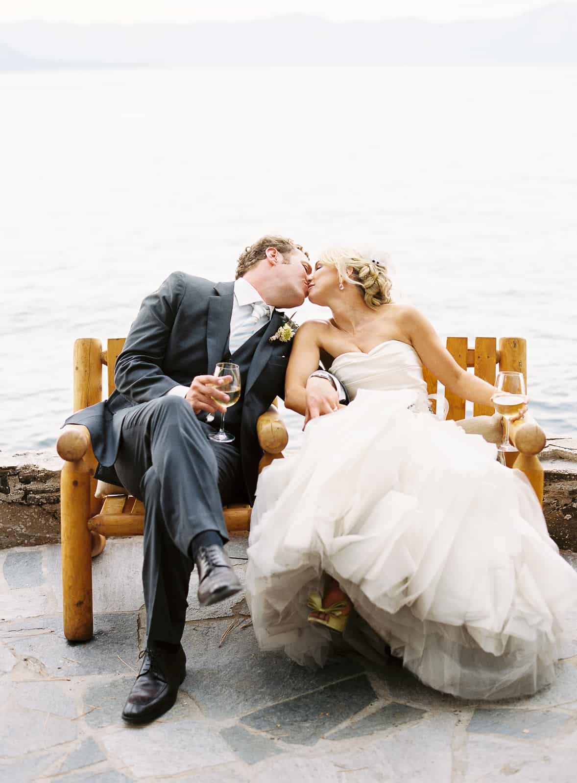 Married couple kissing beside Lake Tahoe