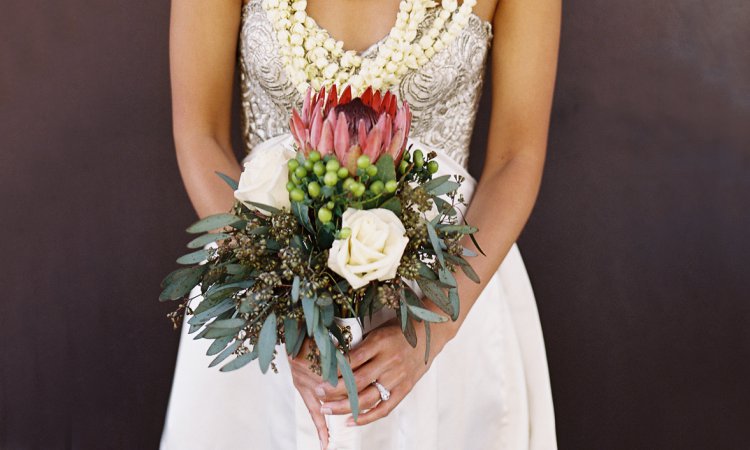 Bride portrait with protea bouquet and lei