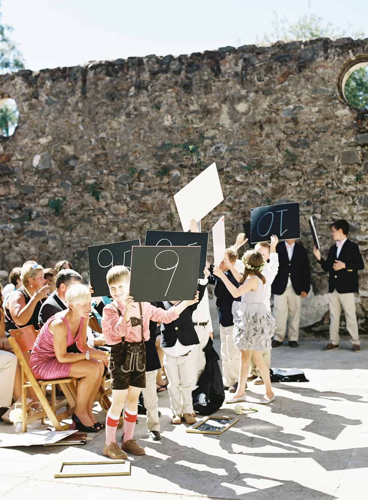 junior wedding party holding score cards