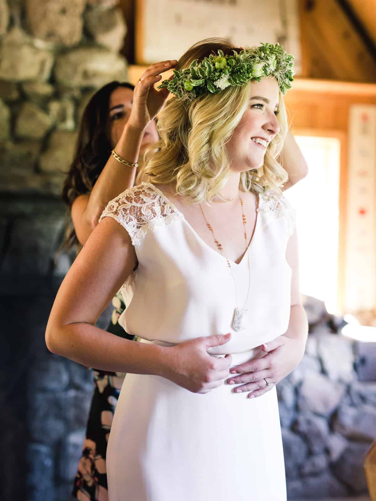 bride putting on green flower crown