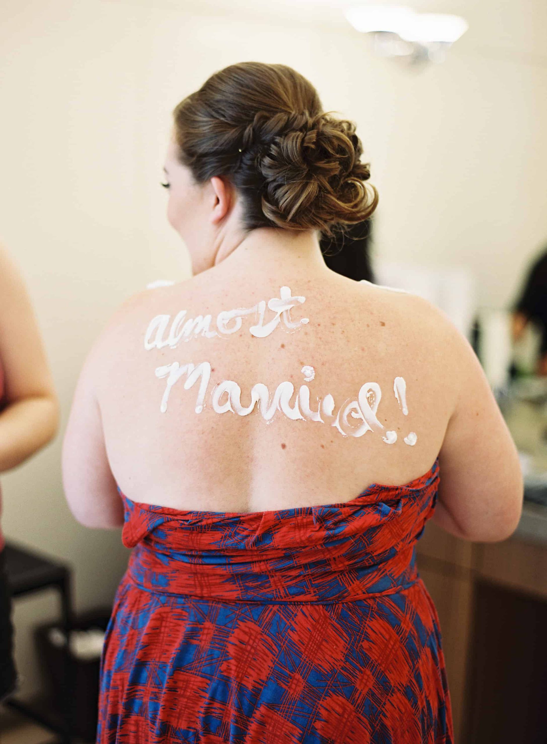 almost maried lotion writing on bride's back