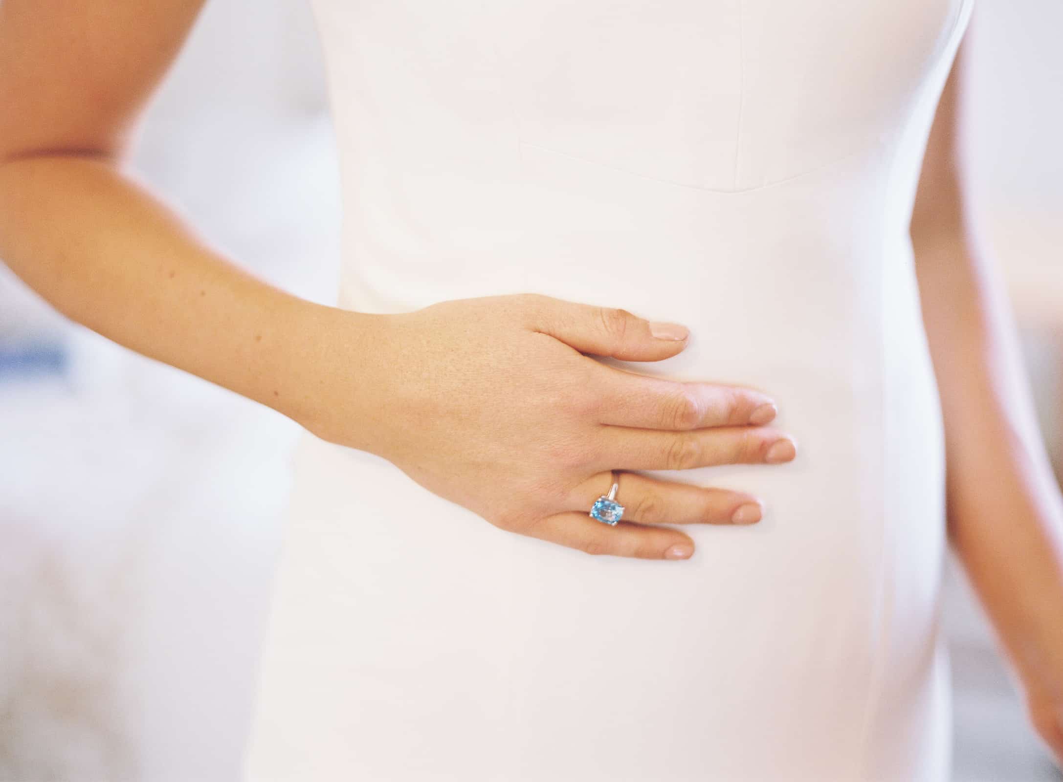 white dress and engagement ring closeup detail