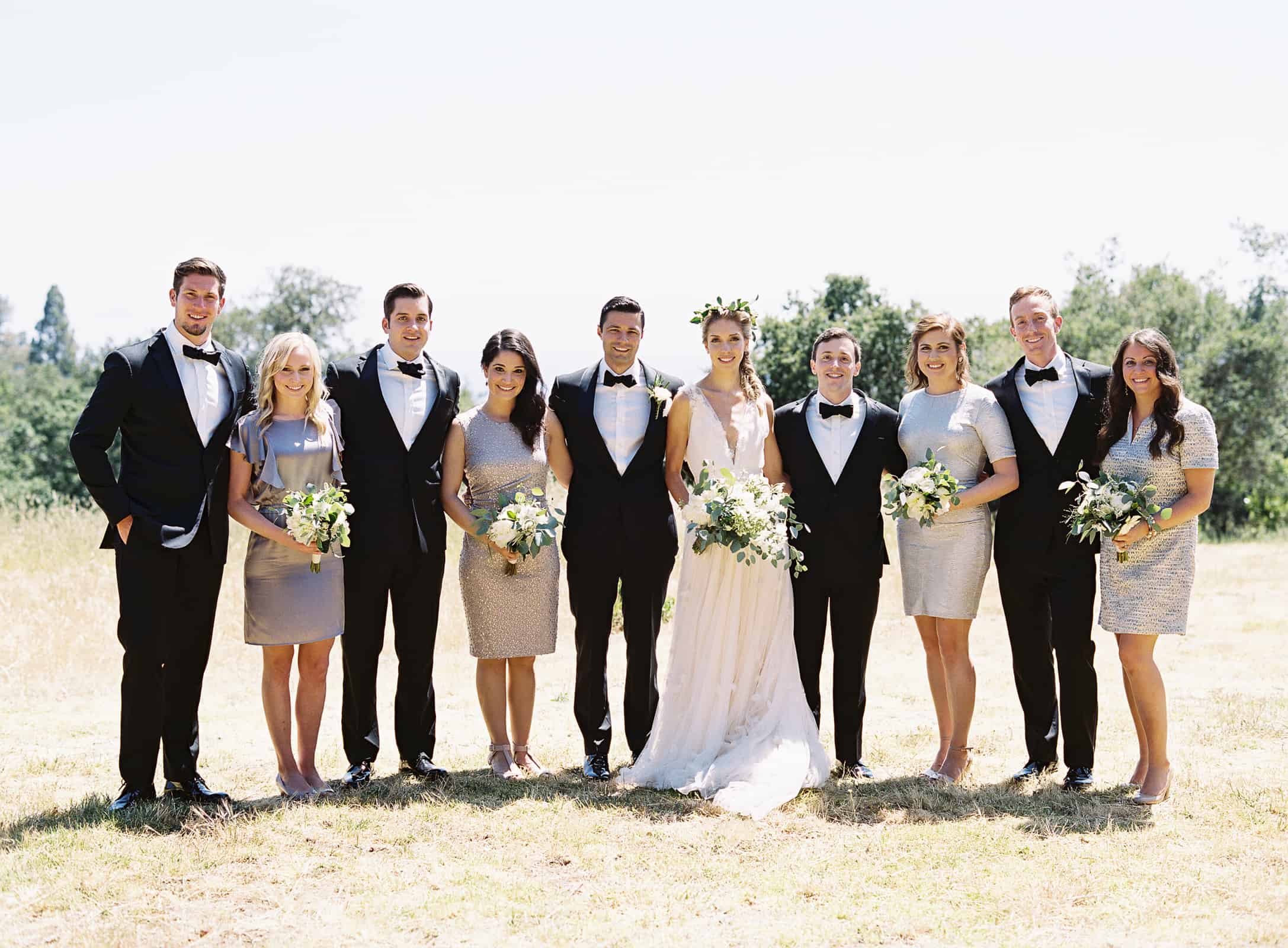 wedding party in black tie tuxedos and silver dresses