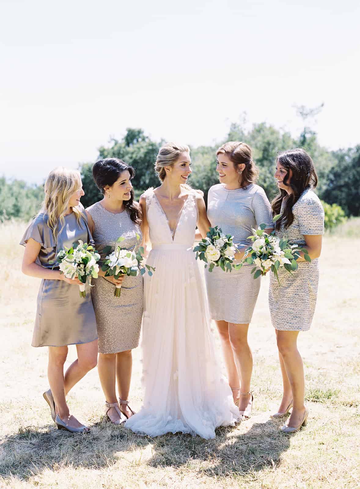 bride with bridesmaids in silver dresses