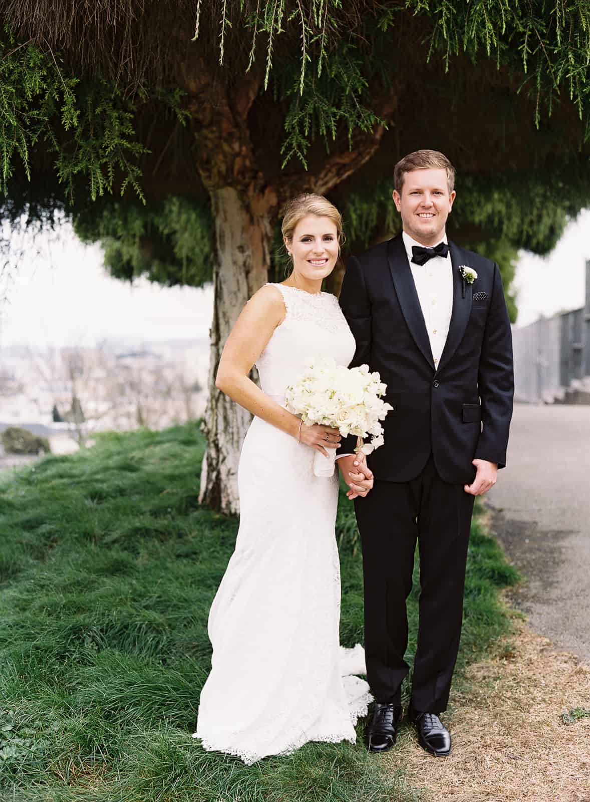 bride and groom under a tree