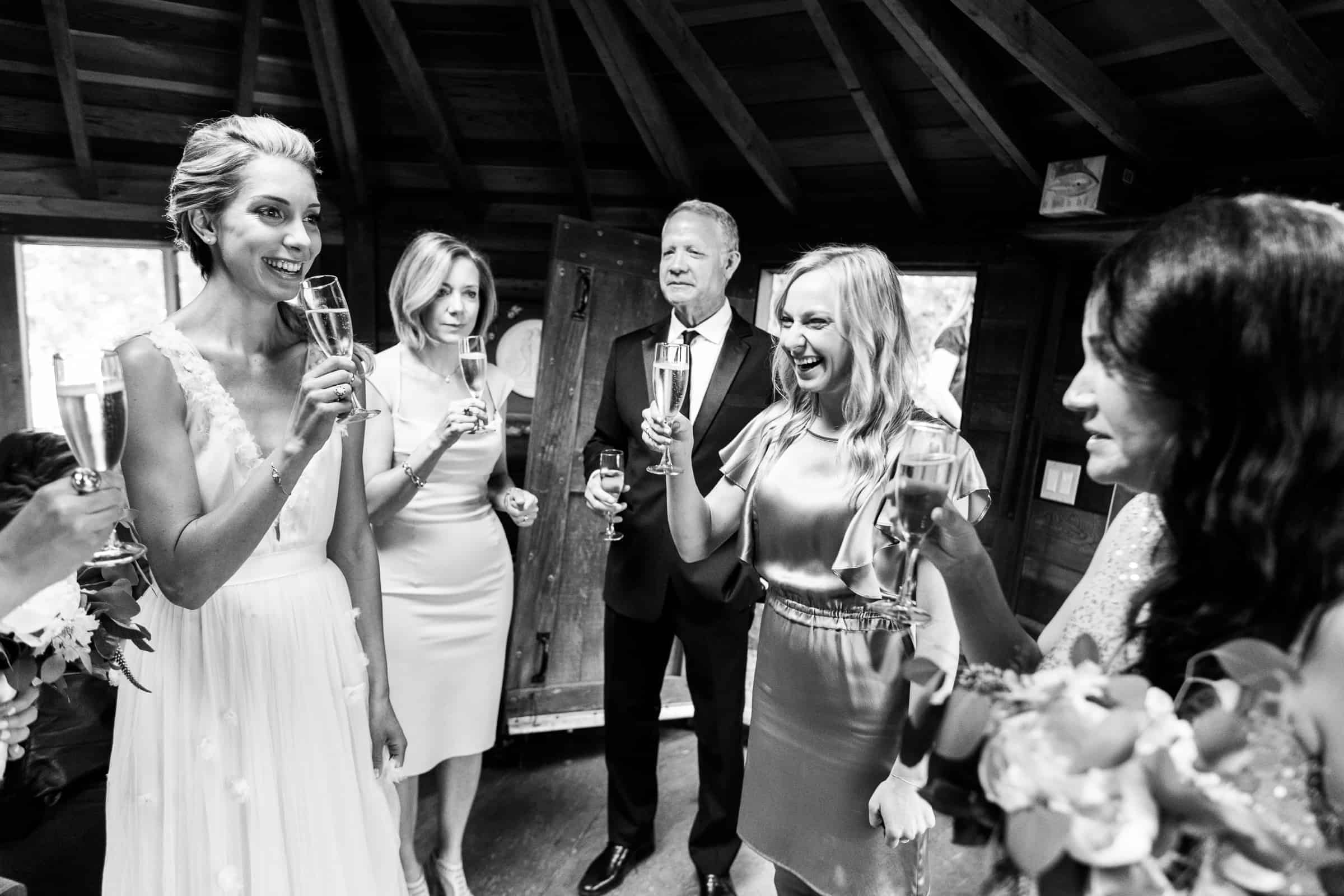 bridal party drinking champagne in a yurt