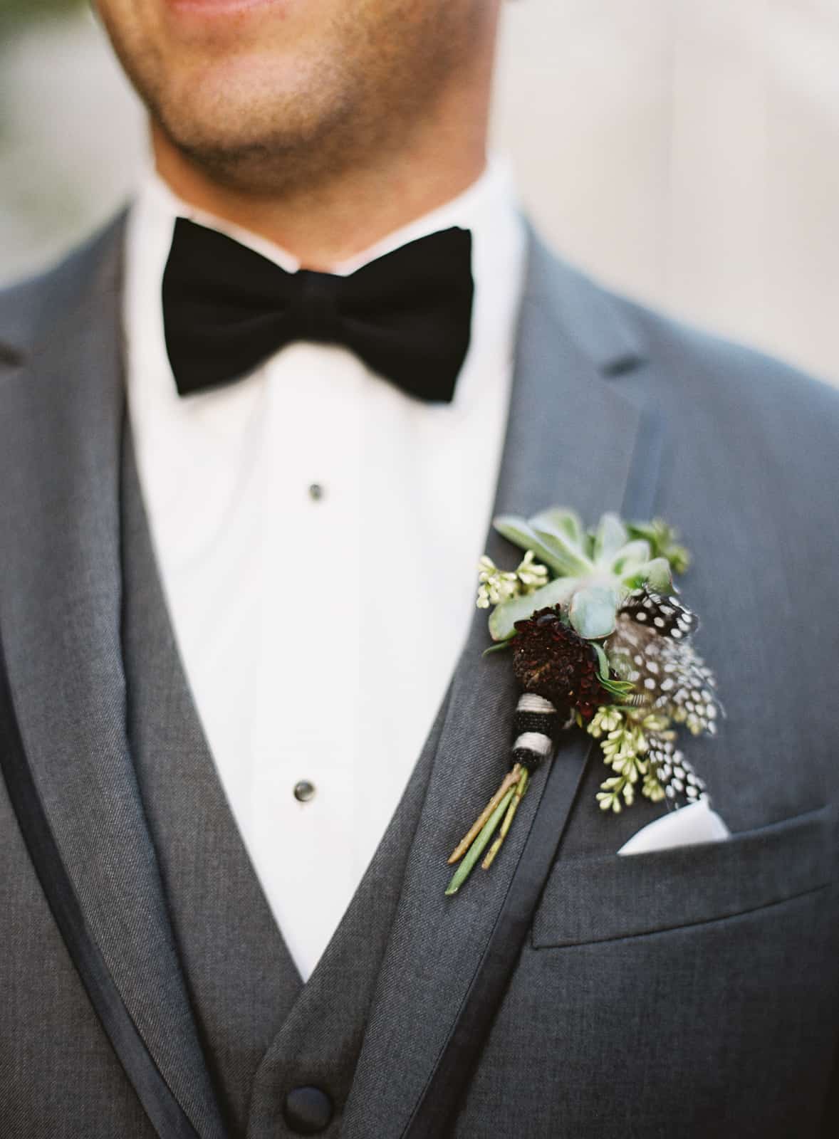 details groom boutonniere green succulent feathers
