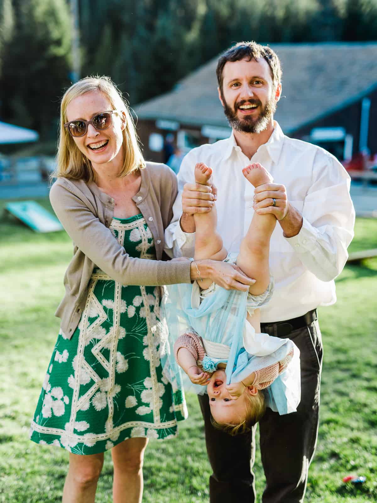 funny photo of guests holding kid upside down