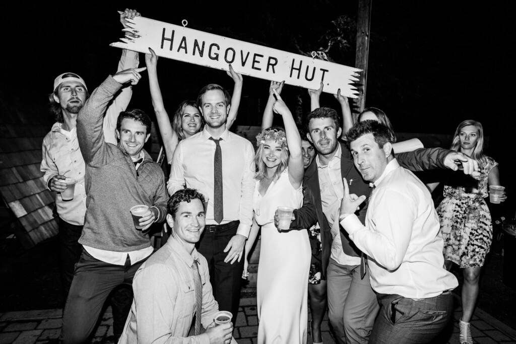 group holding hangover hut sign