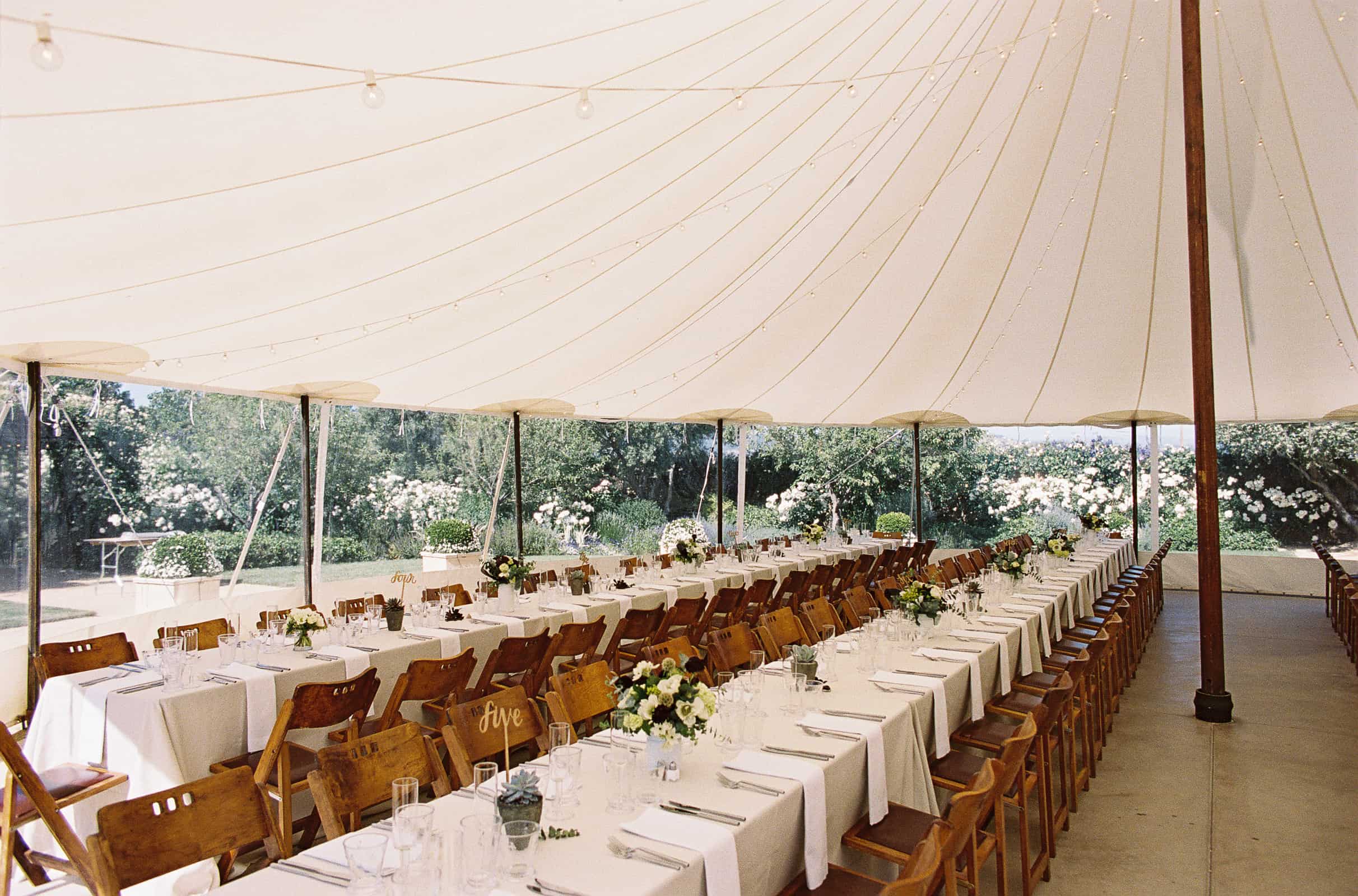 detail wedding dinner long tables in circus tent