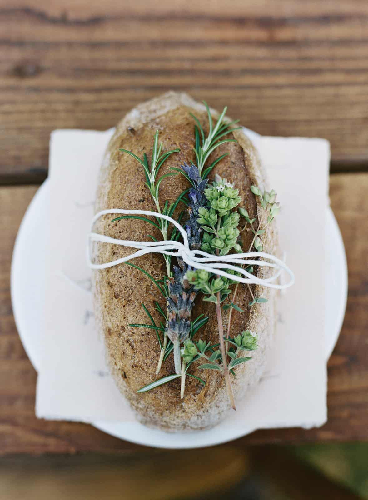 rustic bread loaf with herbs tied on top