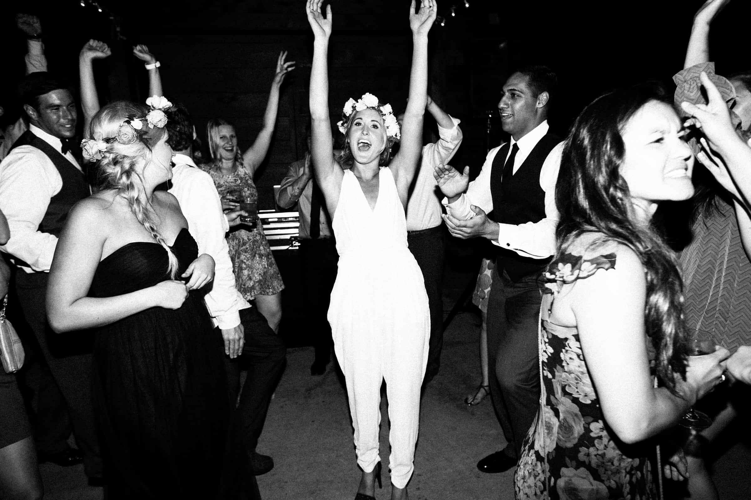 bride waving hands in the air dancing