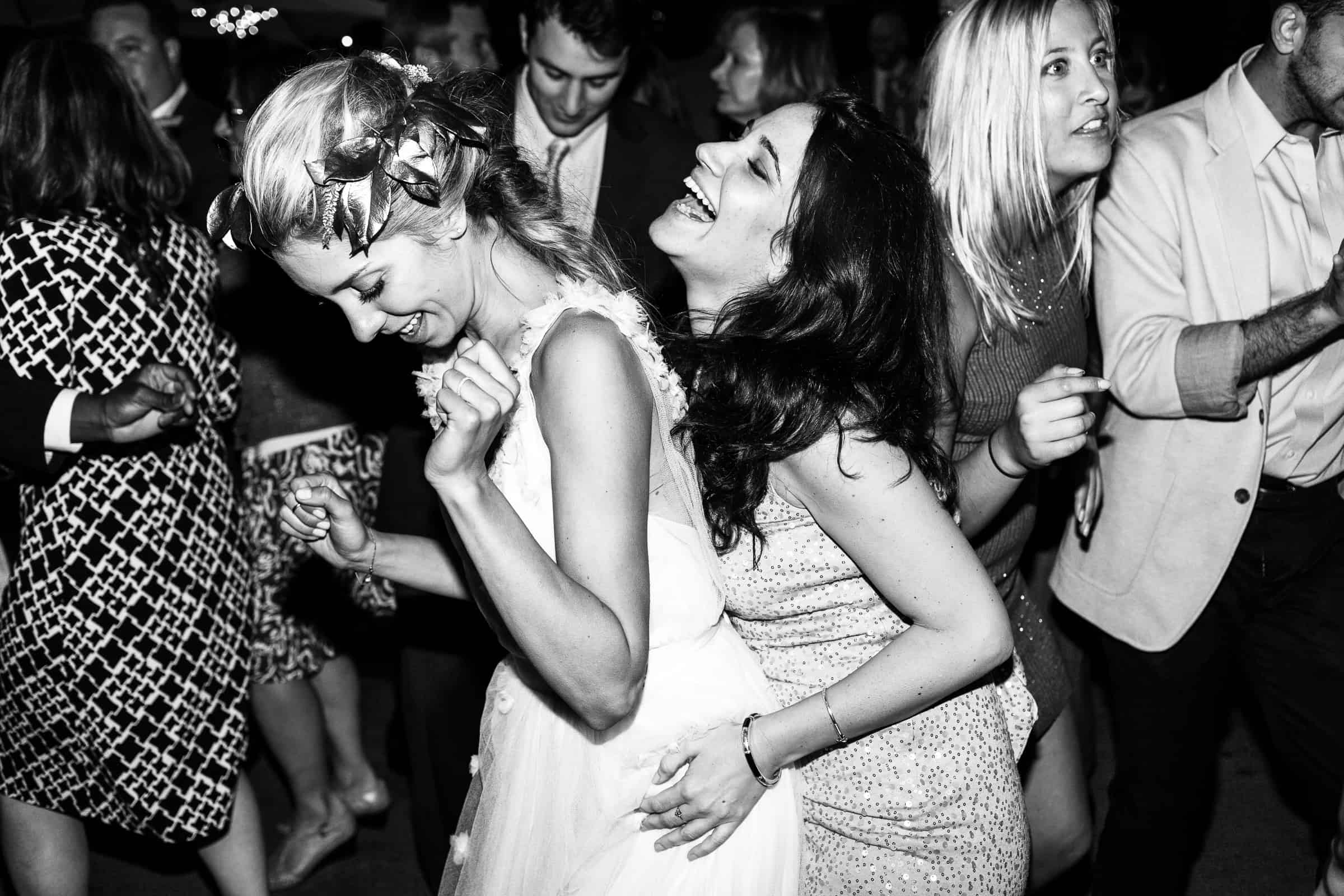 bride and maid of honor dancing