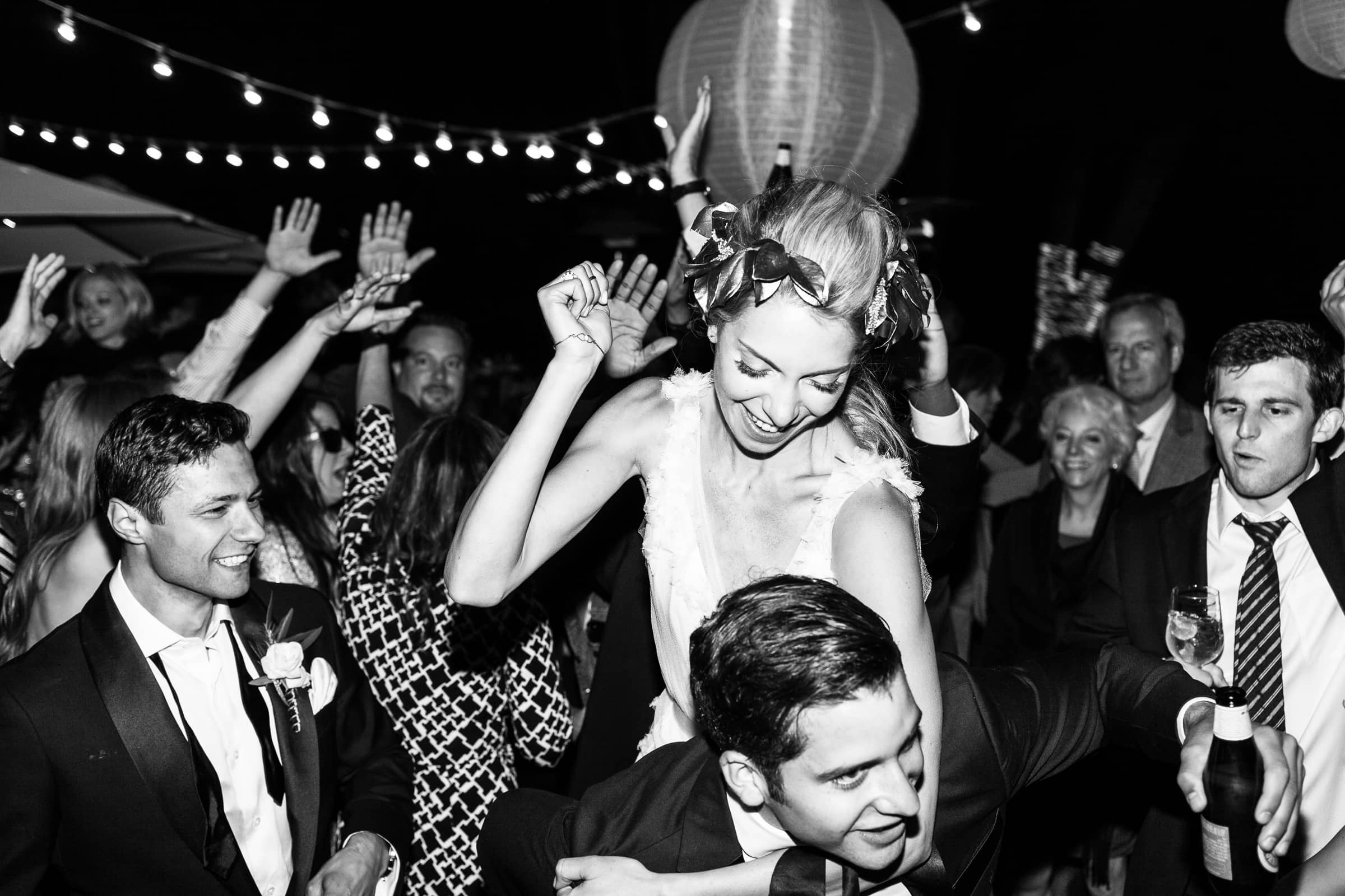 bride being carried on the dance floor
