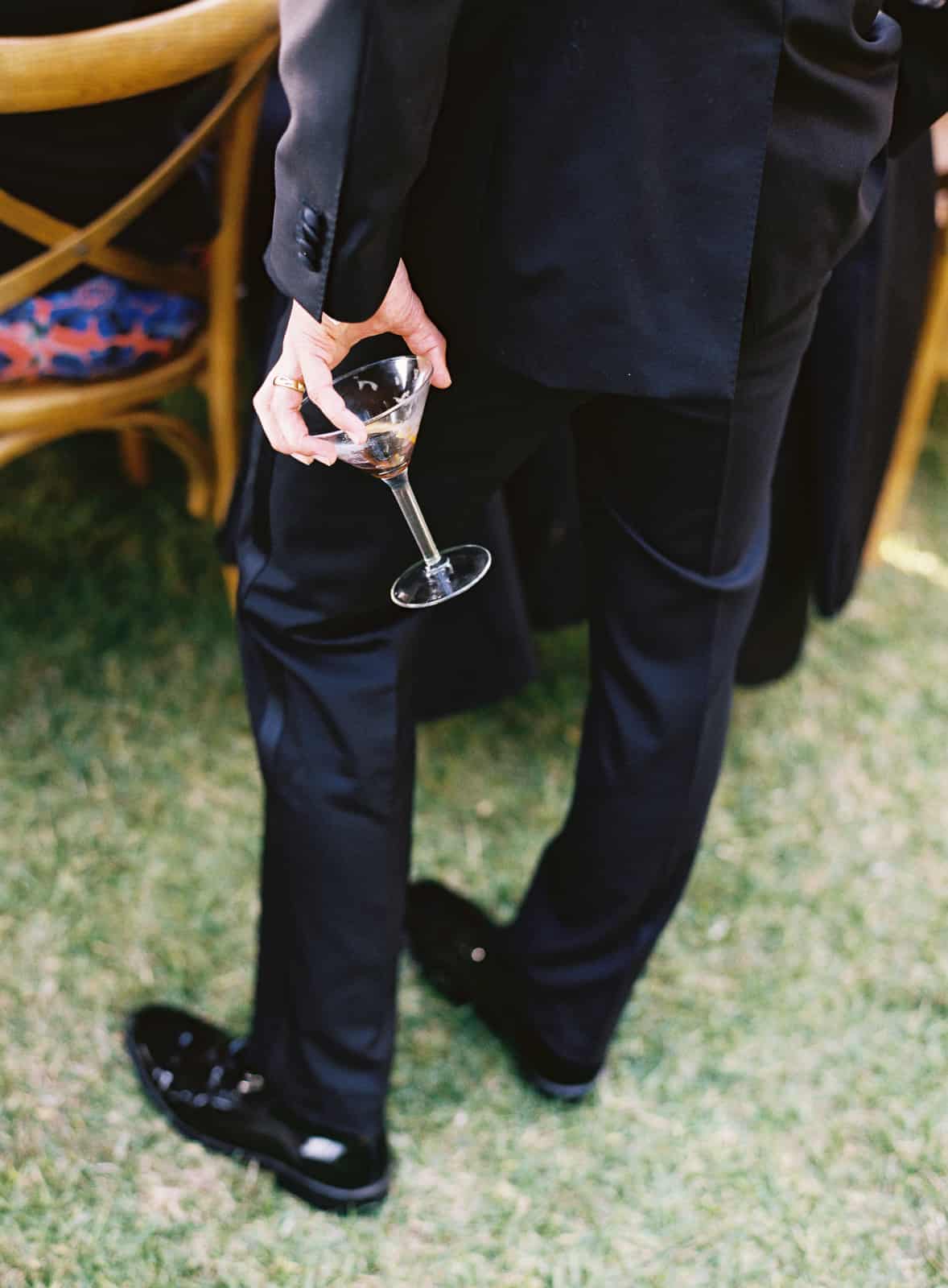 man in tuxedo holding martini glass