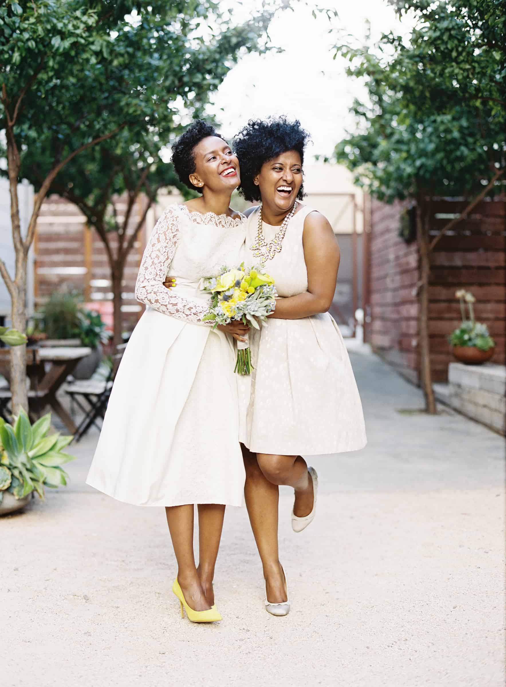african american  bride and bridesmaid in short dresses