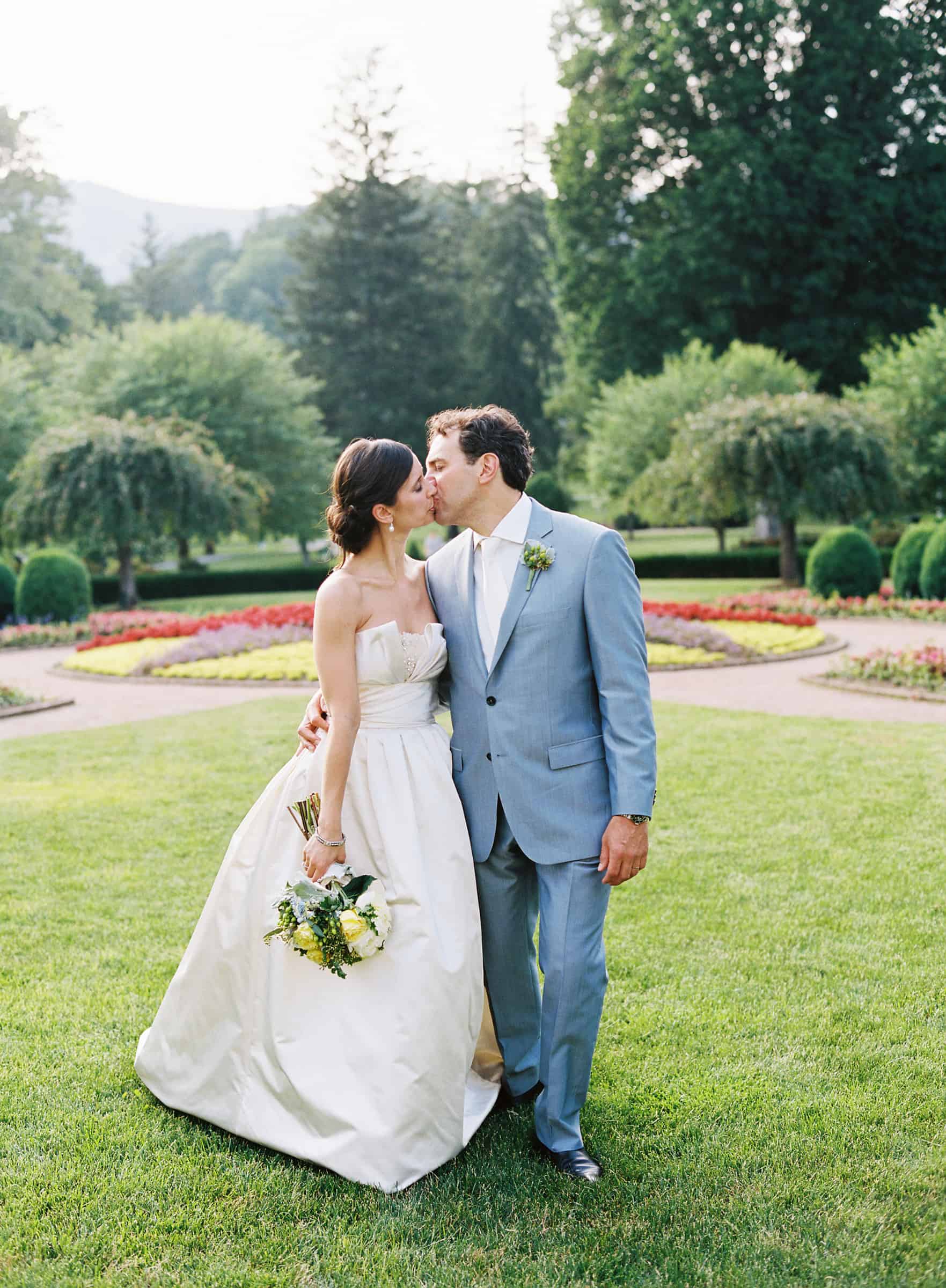 bride and groom kissing and walking at Greenbrier resort