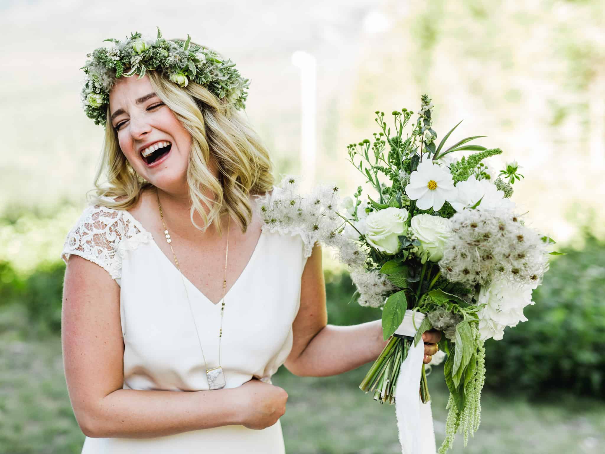 bride laughing with flowers at mount hood ski bowl wedding