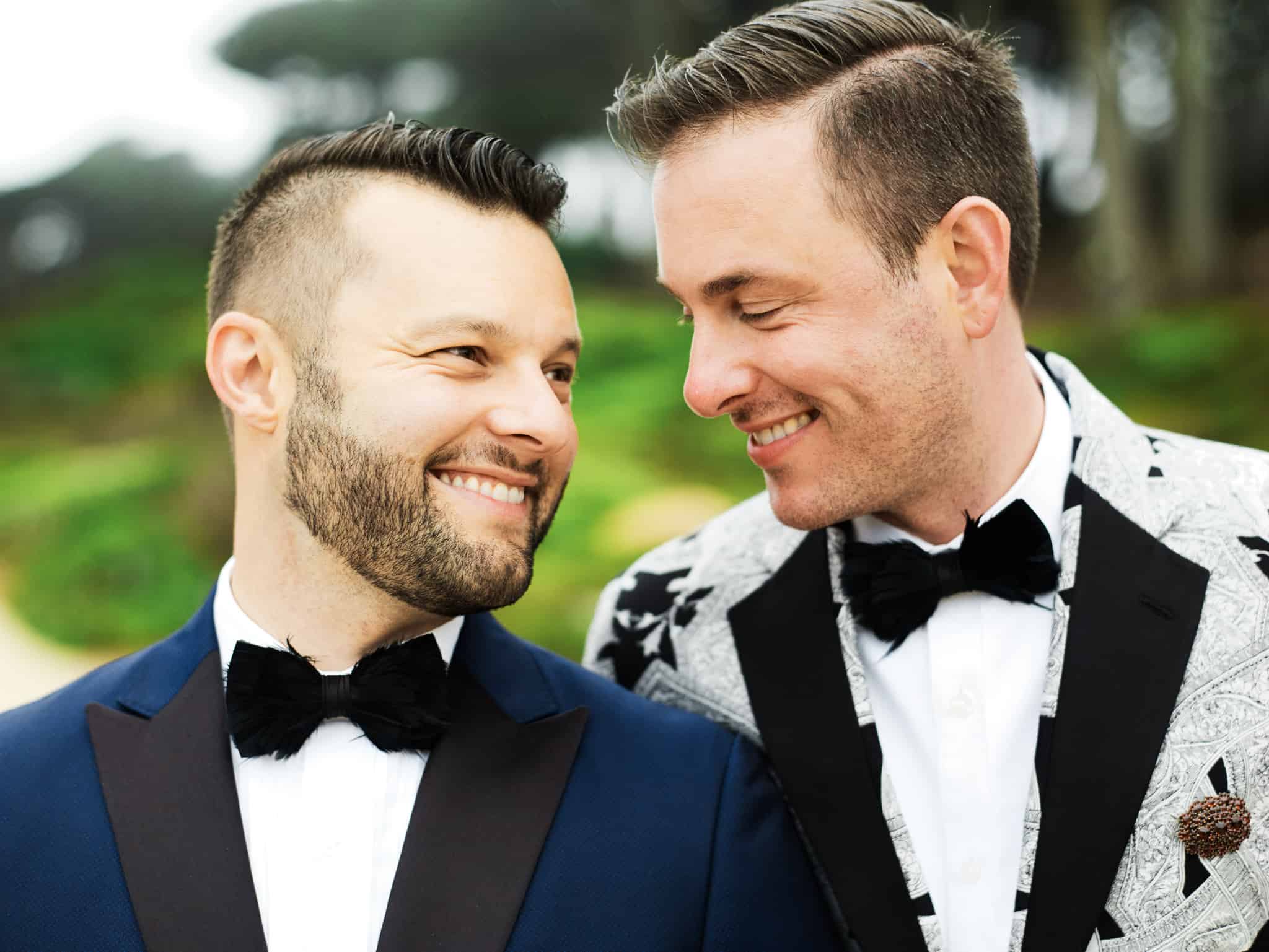 gay same sex wedding couple in san francisco wearing colorful tuxedos
