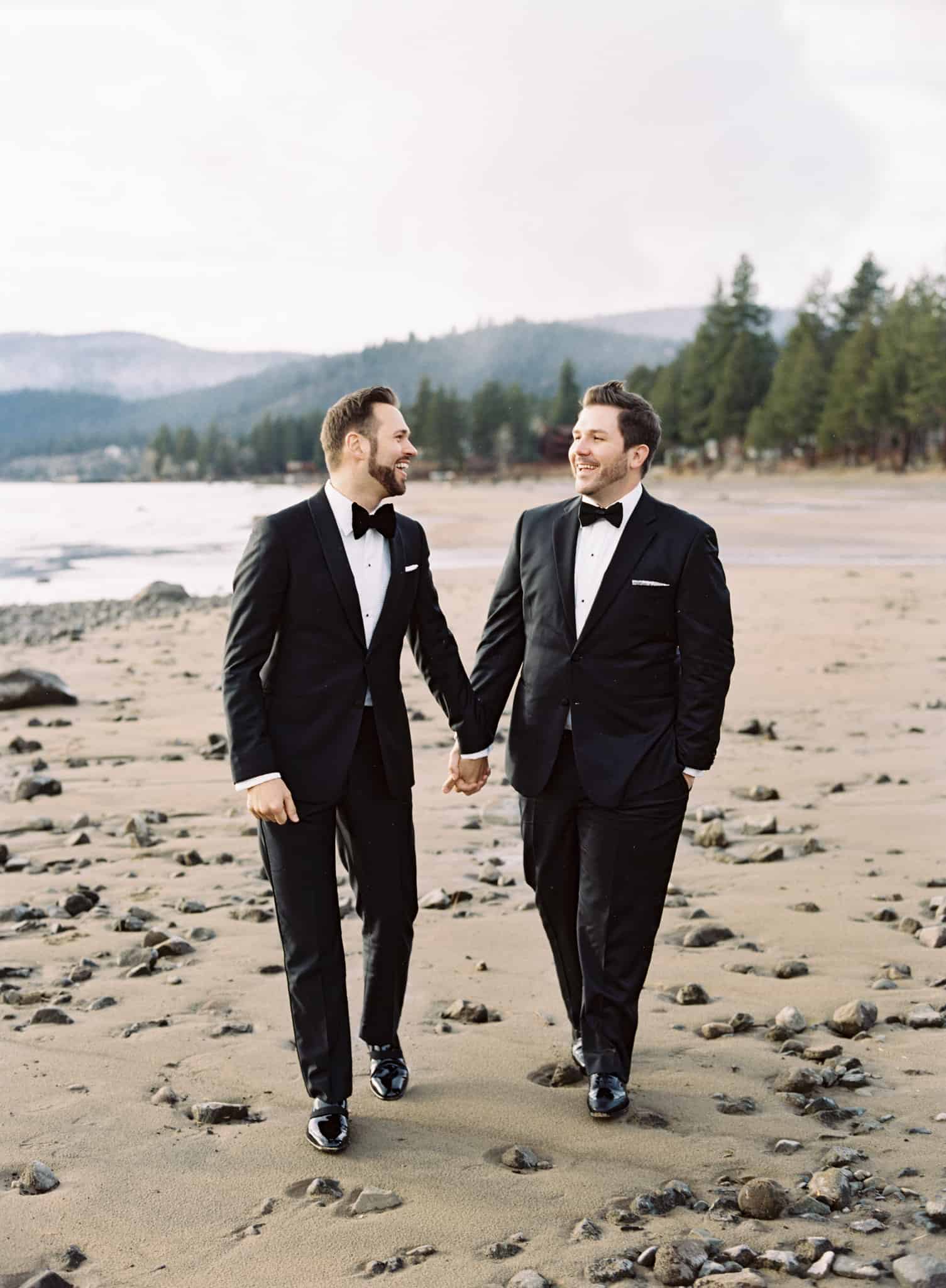 gay couple walking on lake tahoe beach