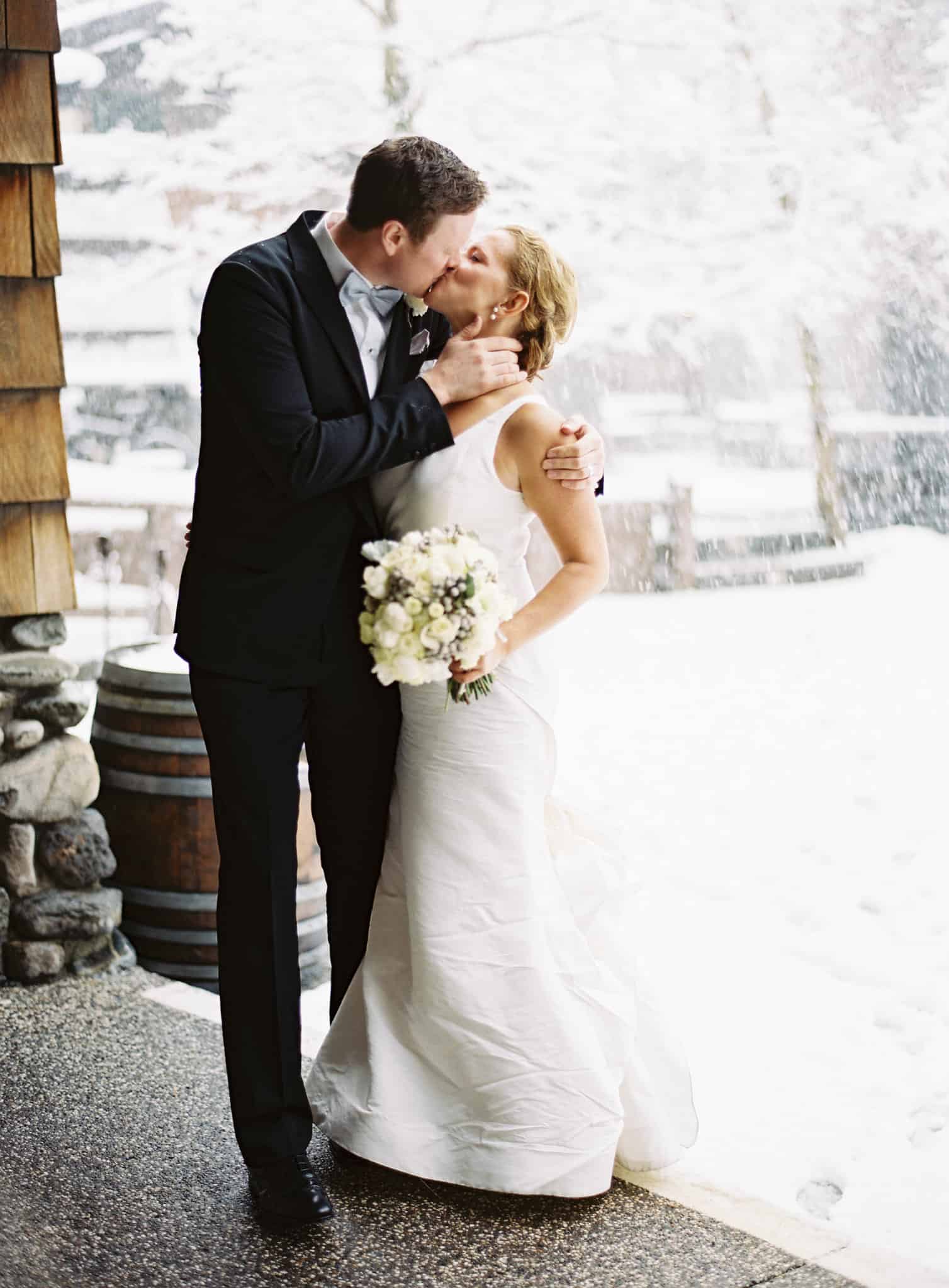 couple kissing in snow at Plump Jack Squaw Valley Inn wedding
