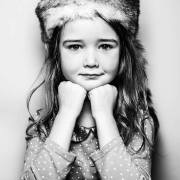 iconic kid portrait of girl in fur hat