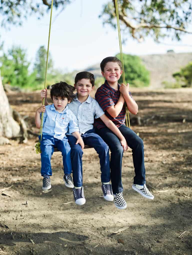 brothers on hippie tree swing during family photo session in tiburon