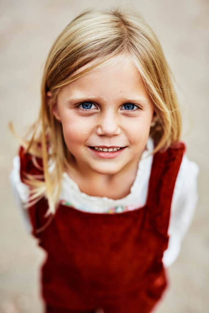 closeup potrait of girl in red overalls