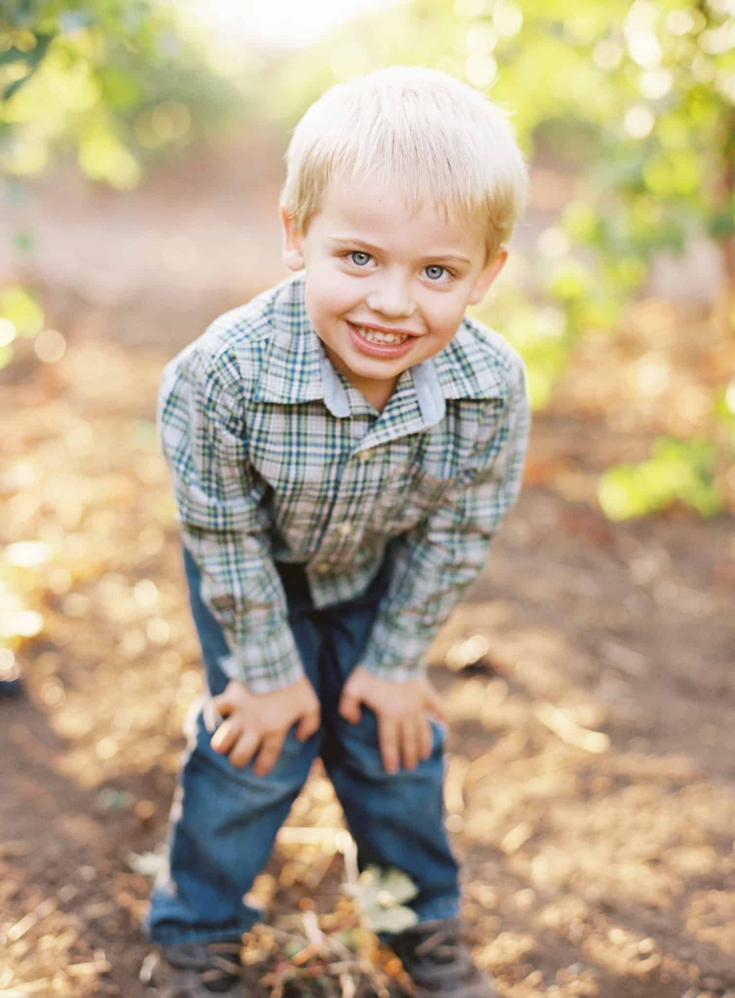 Boy posing for photo in vineyard